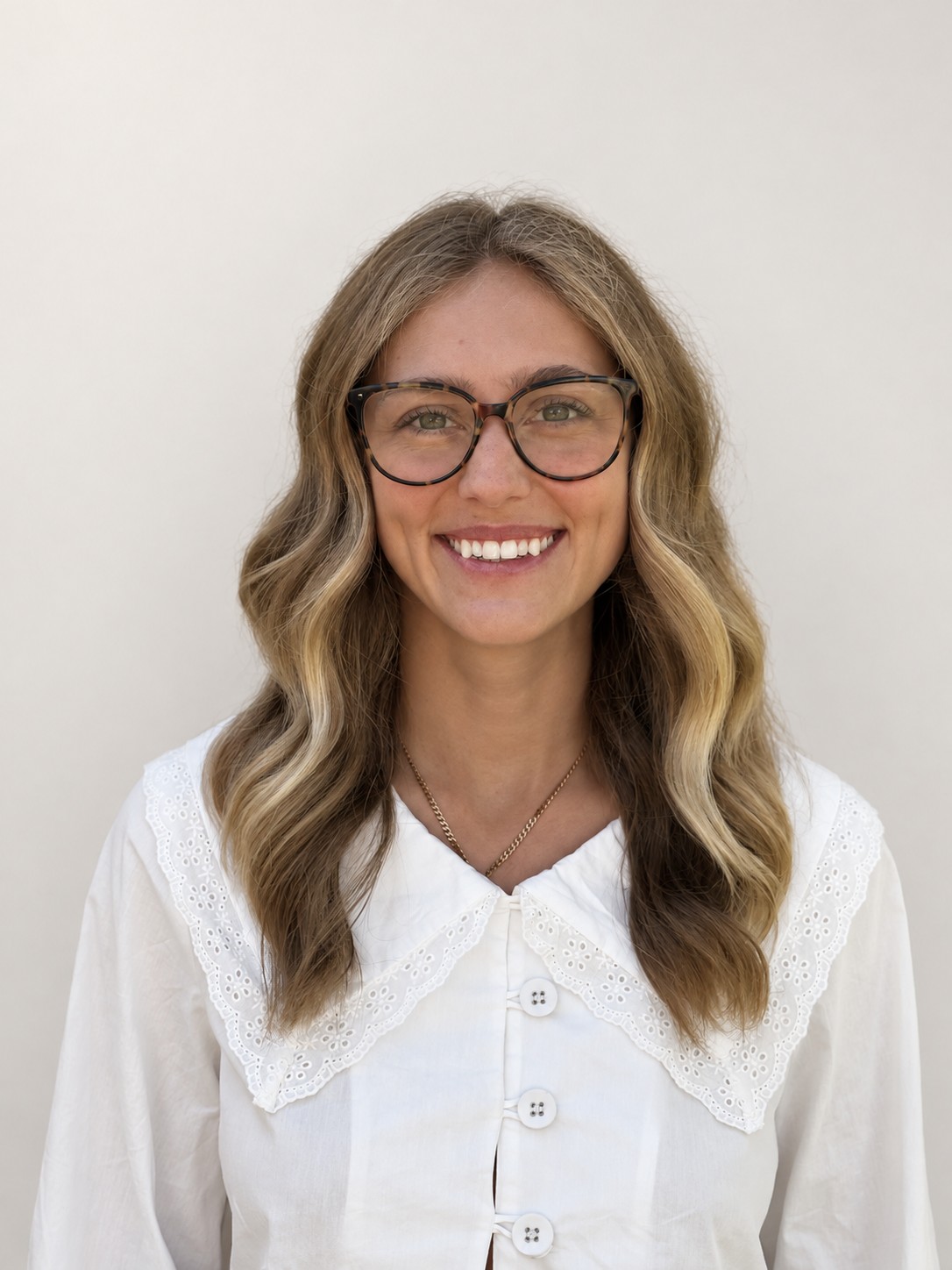 Naomi Lutz, LMFT, smiling, wearing glasses